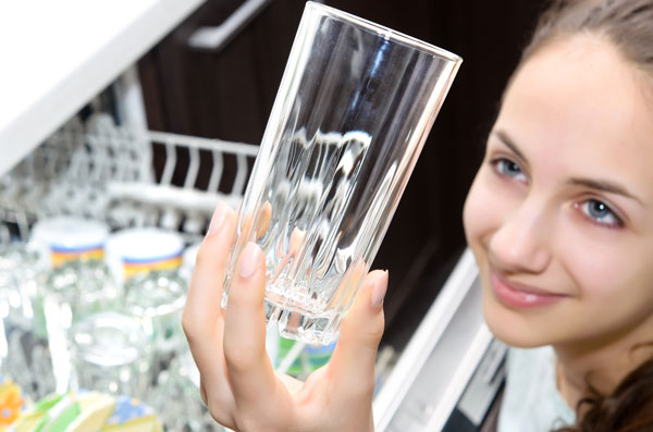 girl cleaning dishes from dishwasher